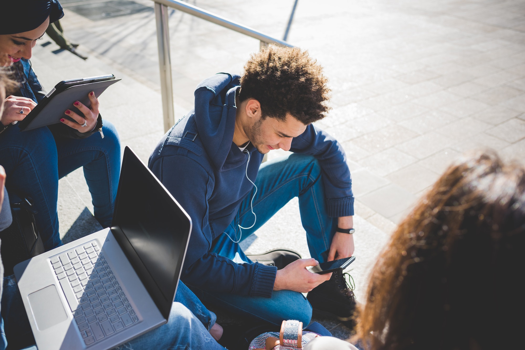 Multiracial group young people using technology